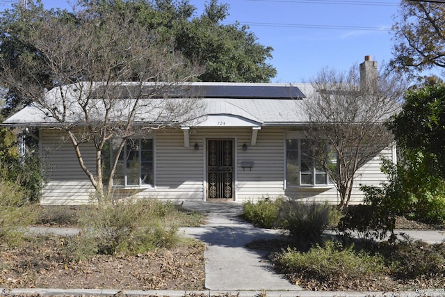 ranch-style house featuring solar panels