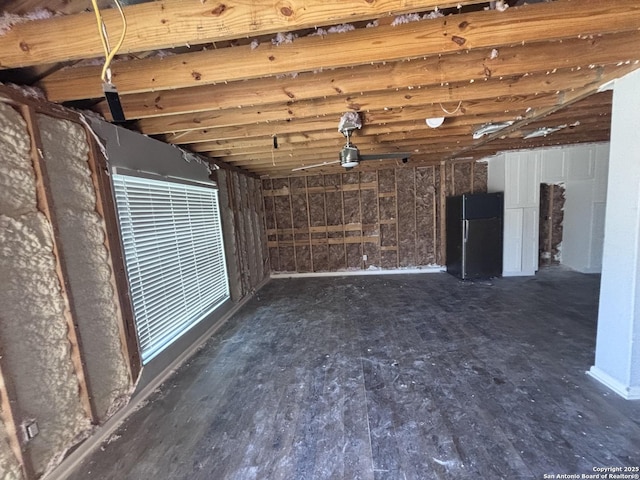 interior space with a garage and freestanding refrigerator