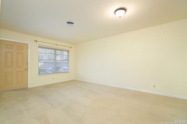 unfurnished room with light carpet, baseboards, and visible vents