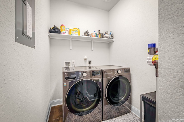 clothes washing area featuring wood finished floors, laundry area, baseboards, and separate washer and dryer