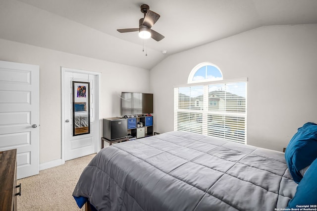 carpeted bedroom featuring vaulted ceiling, ceiling fan, and baseboards