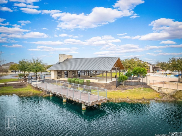 view of dock featuring a water view and fence