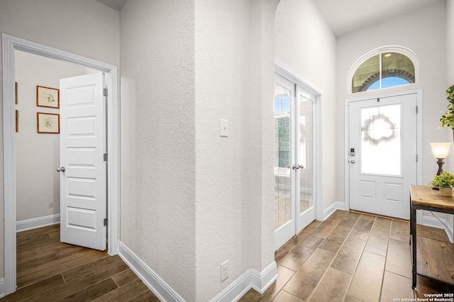 entryway with baseboards and wood finished floors