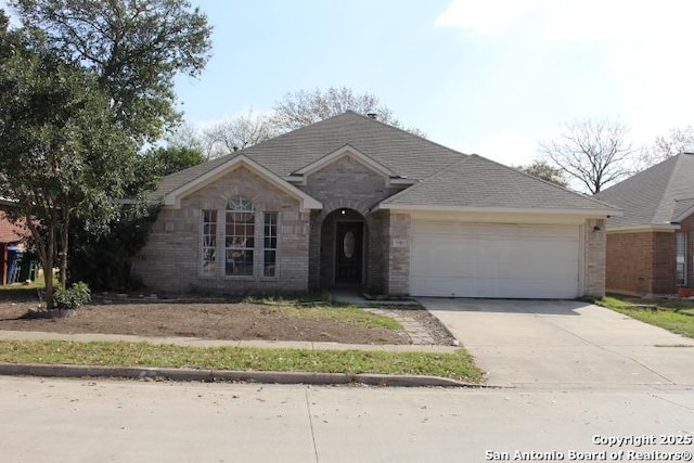 ranch-style home with brick siding, driveway, and an attached garage