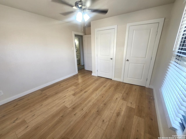 unfurnished bedroom with light wood-style flooring, baseboards, ceiling fan, and a closet