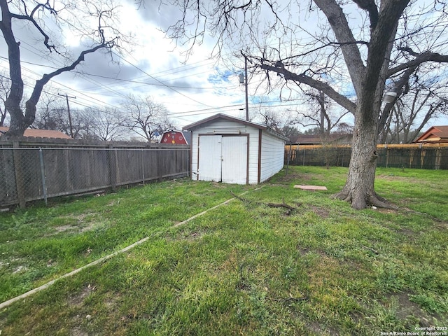 view of yard with a storage shed, an outdoor structure, and a fenced backyard