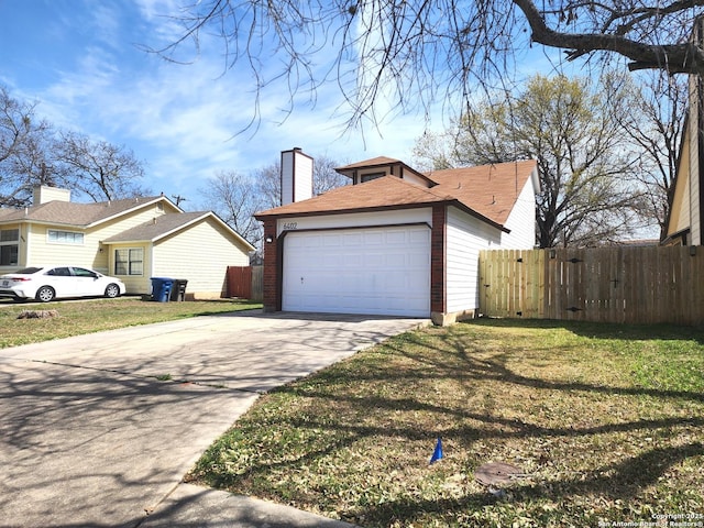 view of home's exterior featuring concrete driveway, fence, a chimney, and a lawn