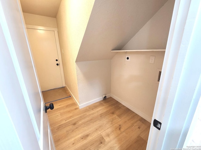 laundry room with laundry area, light wood-style flooring, baseboards, and hookup for an electric dryer