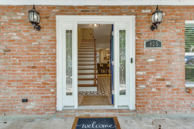 doorway to property with brick siding