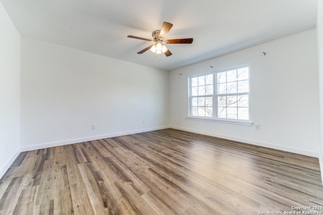 unfurnished room with ceiling fan, baseboards, and wood finished floors