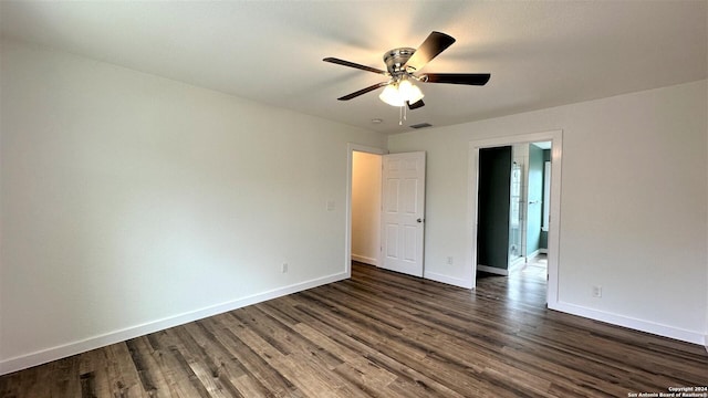 unfurnished room with visible vents, baseboards, dark wood finished floors, and a ceiling fan