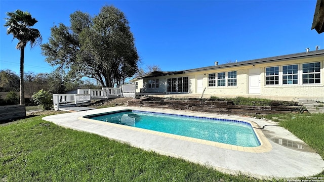 pool featuring a deck and a yard