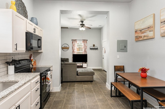 kitchen with backsplash, a ceiling fan, white cabinets, light stone countertops, and black appliances