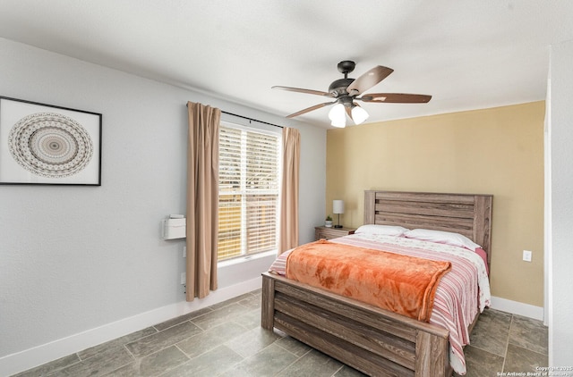 bedroom with baseboards and a ceiling fan