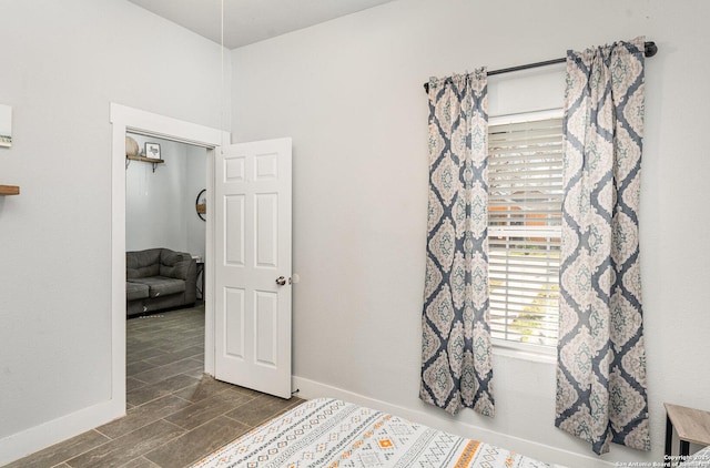 bedroom with wood finish floors and baseboards