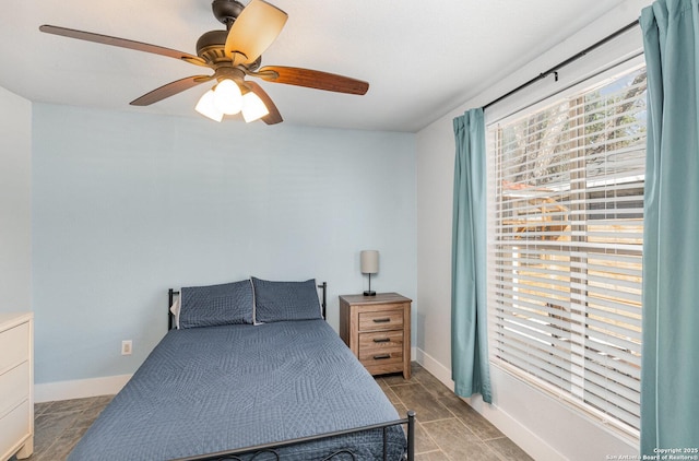 bedroom featuring a ceiling fan and baseboards