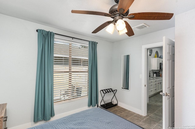 bedroom with dark tile patterned flooring, visible vents, ceiling fan, and baseboards