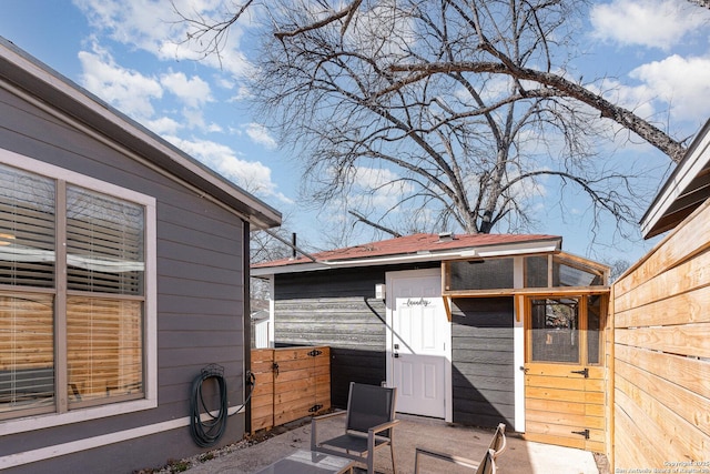 exterior space with fence and an outbuilding