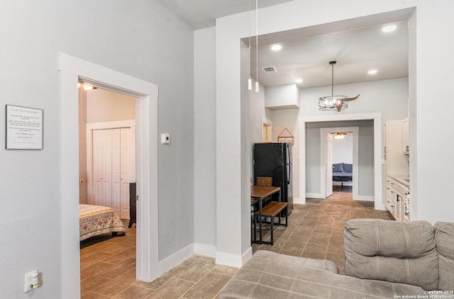 interior space featuring baseboards, visible vents, and recessed lighting