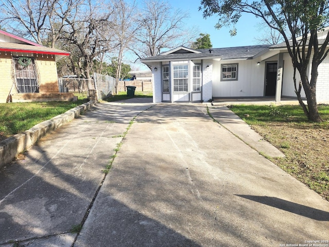 view of street with concrete driveway