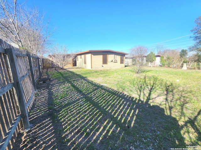 view of yard featuring an outbuilding and a fenced backyard