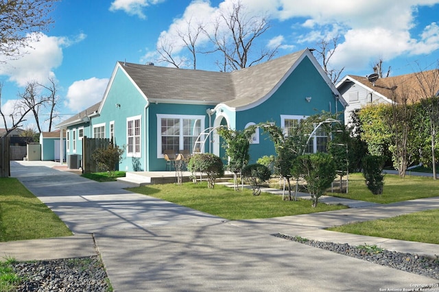 view of front of house with a front lawn, cooling unit, and stucco siding