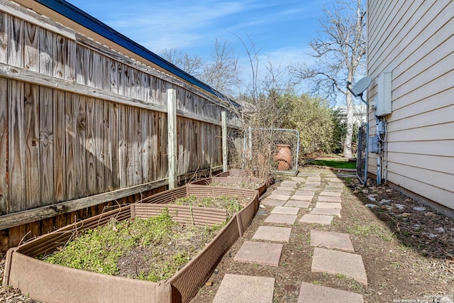 view of yard with a garden and fence