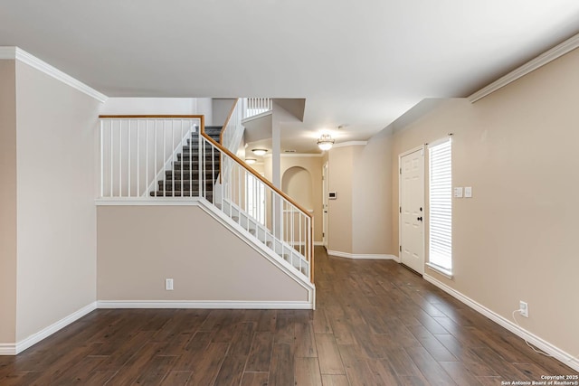 entrance foyer featuring wood finished floors, a healthy amount of sunlight, baseboards, and stairs