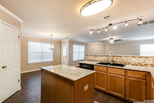 kitchen with a sink, visible vents, black dishwasher, ornamental molding, and a center island