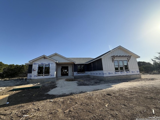 unfinished property featuring board and batten siding