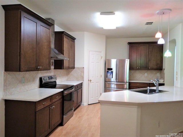 kitchen with stainless steel appliances, a sink, and dark brown cabinetry