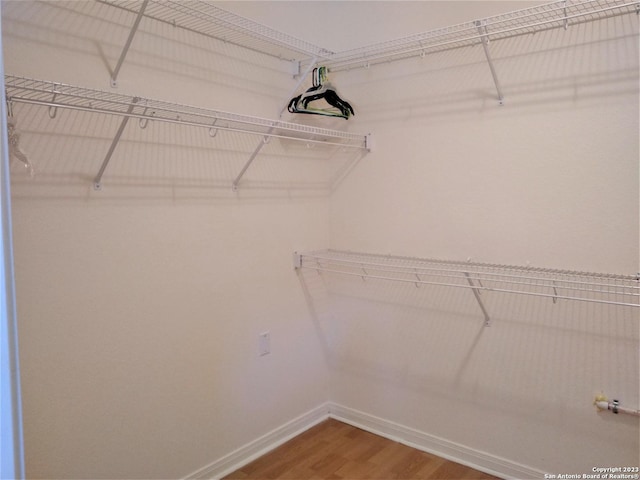 spacious closet with wood finished floors