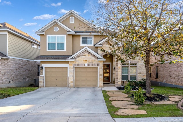 view of front of property featuring an attached garage, driveway, stone siding, and stucco siding