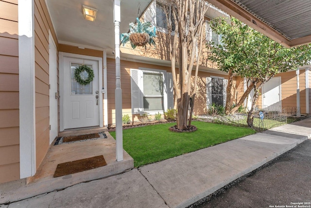 doorway to property with a yard