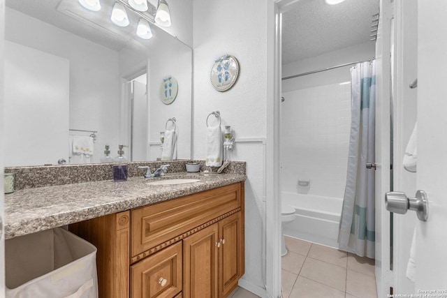 bathroom with toilet, tile patterned flooring, shower / bath combo with shower curtain, a textured ceiling, and vanity