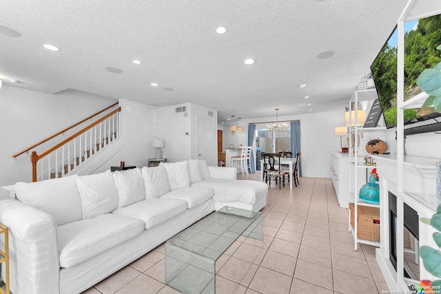 living room with recessed lighting, stairway, a textured ceiling, and light tile patterned flooring