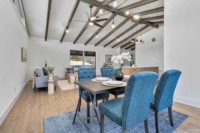 dining area with light wood finished floors, visible vents, vaulted ceiling with beams, and baseboards