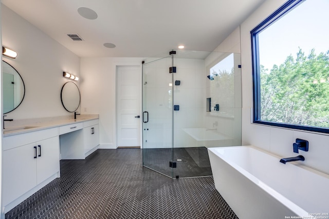 bathroom featuring vanity, visible vents, a freestanding bath, tile patterned floors, and a stall shower