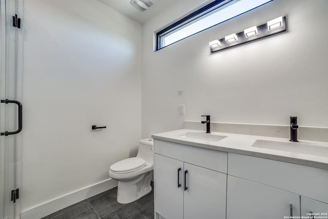 full bathroom with visible vents, a sink, a shower stall, and toilet