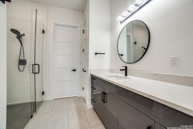 bathroom with a stall shower, tile patterned flooring, and vanity