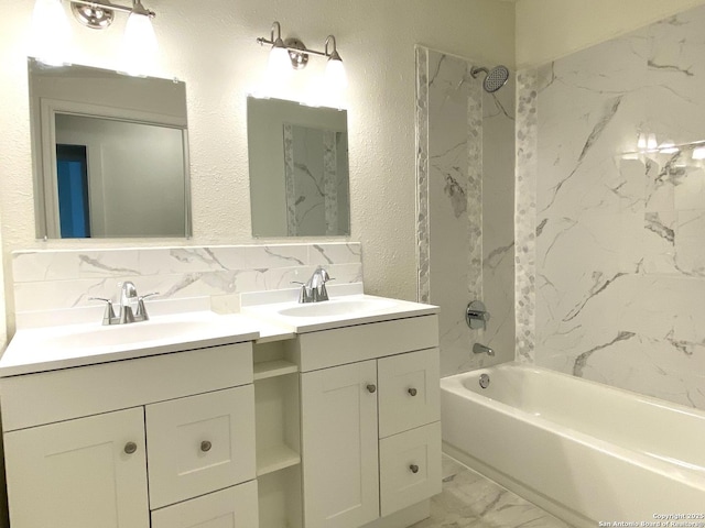 full bath featuring double vanity, shower / tub combination, a sink, marble finish floor, and backsplash