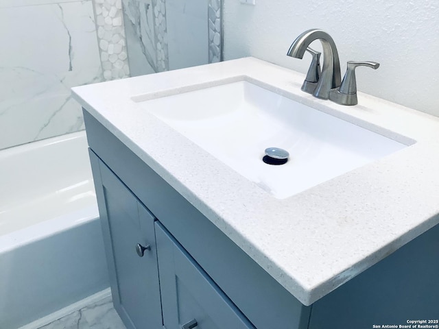 full bath featuring marble finish floor and vanity