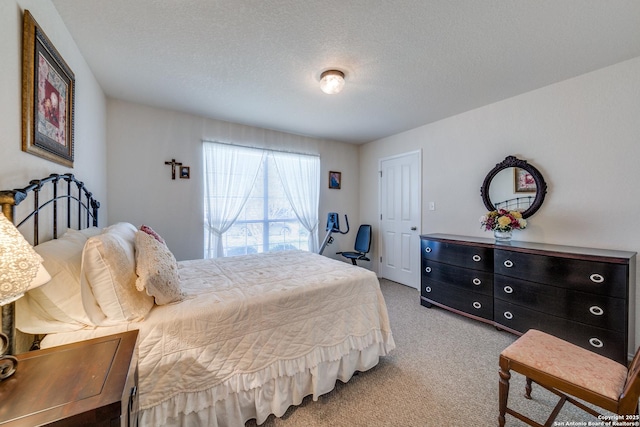 carpeted bedroom with a textured ceiling