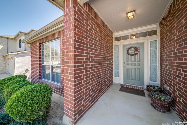 property entrance with brick siding