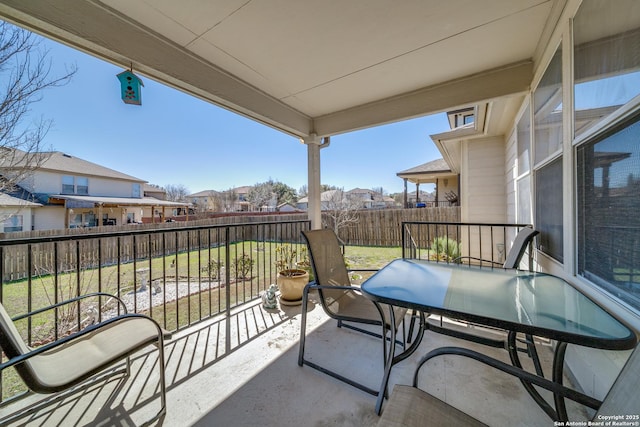 balcony featuring a residential view and outdoor dining area