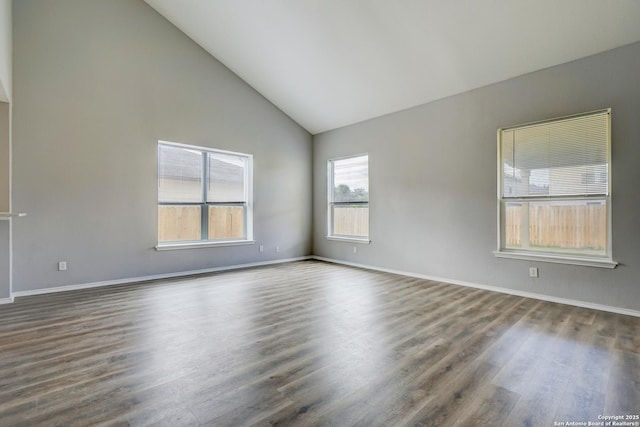 unfurnished room featuring high vaulted ceiling, baseboards, and dark wood-style flooring