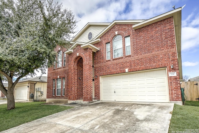 traditional-style house featuring driveway, a garage, fence, a front lawn, and brick siding