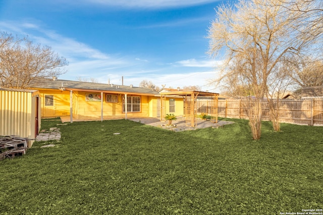 back of house with a lawn, a patio area, and a fenced backyard