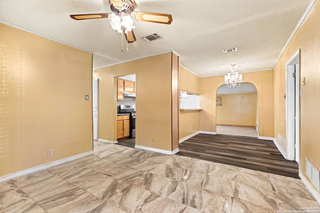 spare room featuring ornamental molding, arched walkways, and visible vents