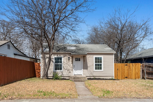 bungalow-style home featuring fence